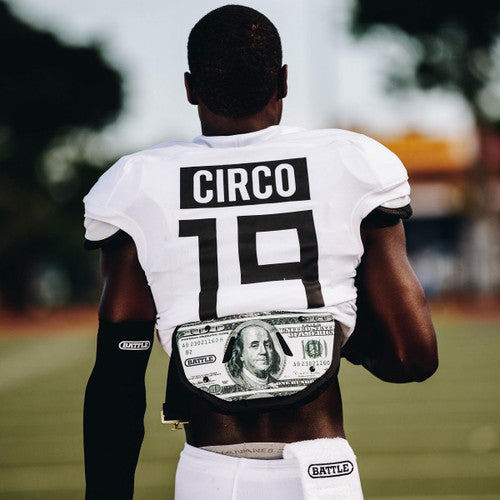 a man in a jersey with a 100 dollar bill Battle back plate on his back