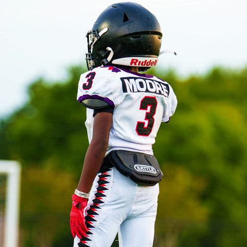 a football player wearing a black Battle back plate with the word battle on it written in white