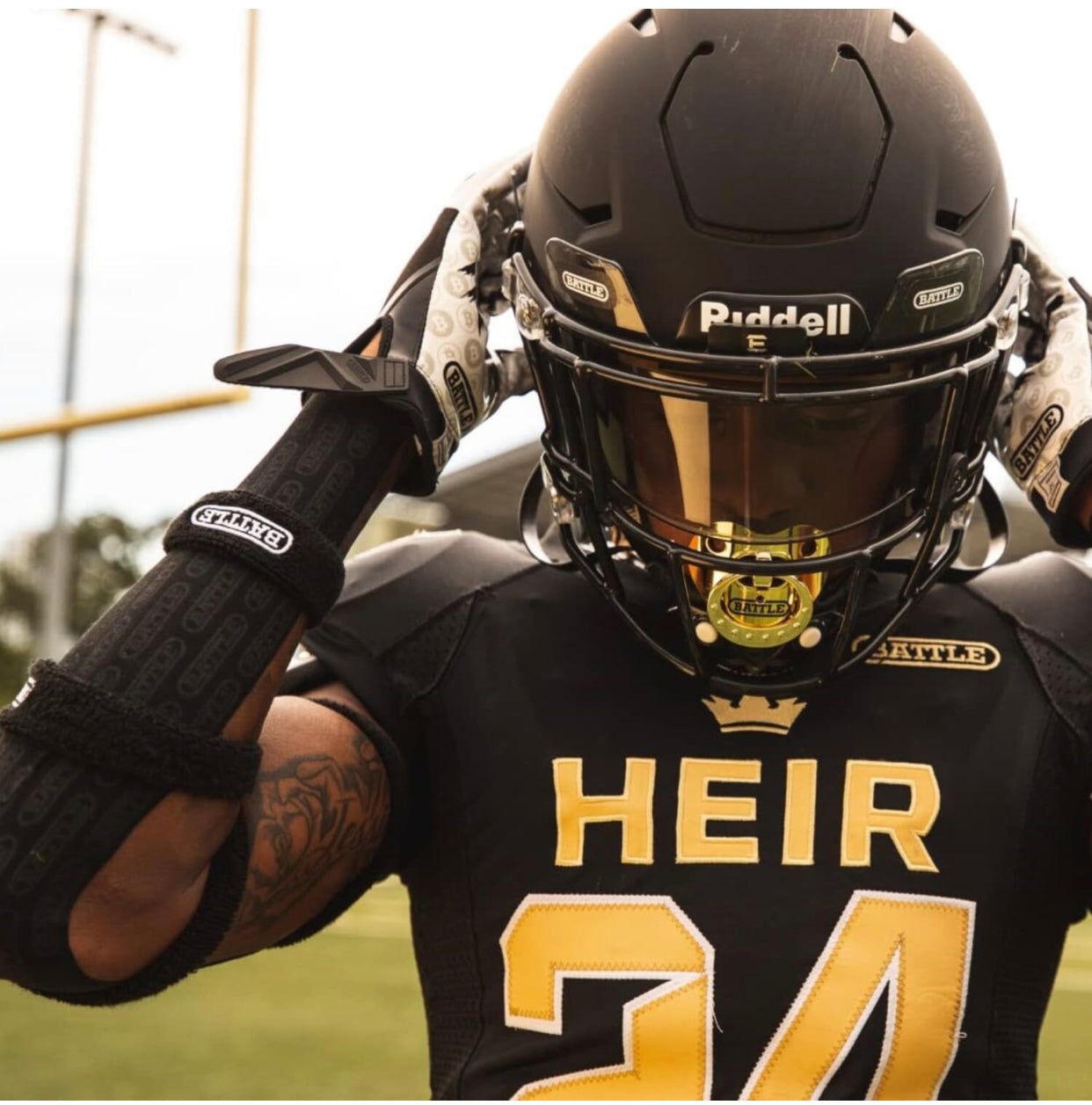 a football player with a helmet and gloves on with black battle tape